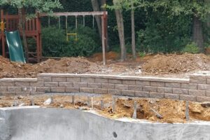 Hardscaping Projects in Charlotte, NC, featuring installation of retaining wall and concrete patio