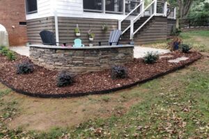 Mulch bed and lawn care services by Top Gardens Landscaping.