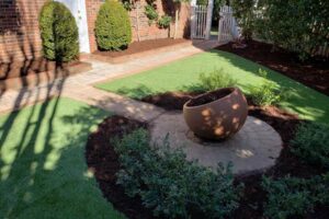 landscape feature installation and lawn care services by Top Gardens Landscaping.