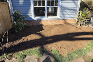 Top garden landscaping in progress featuring a leveled dirt plot ready for planting at a home in Charlotte, NC.